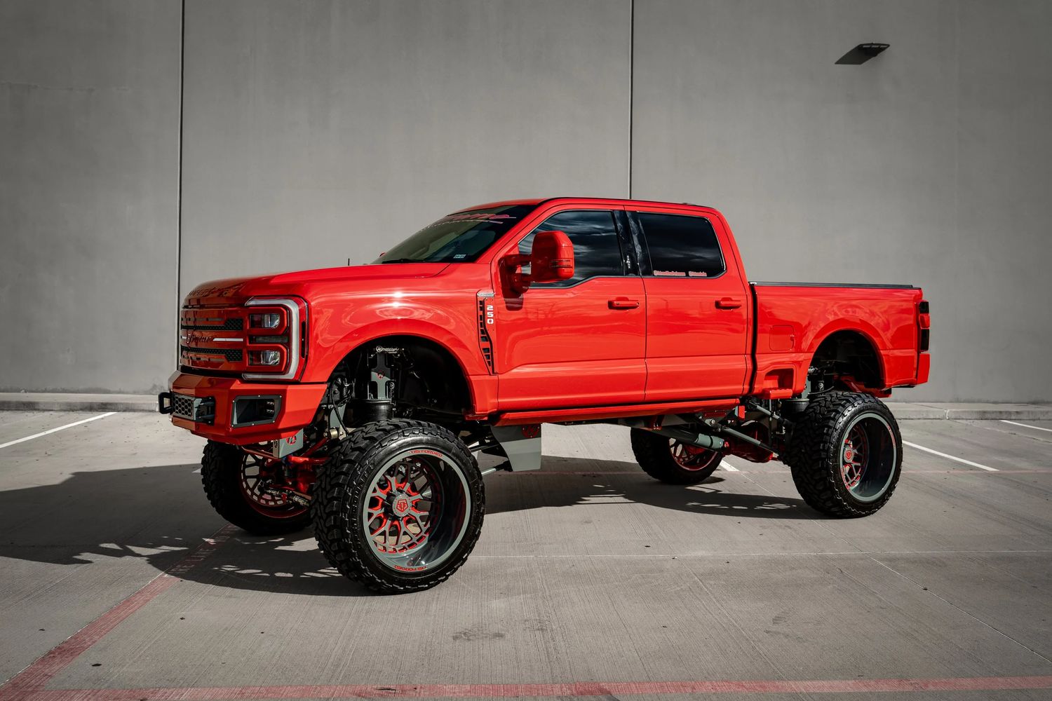 Red lifted Ford Super Duty on forged wheels