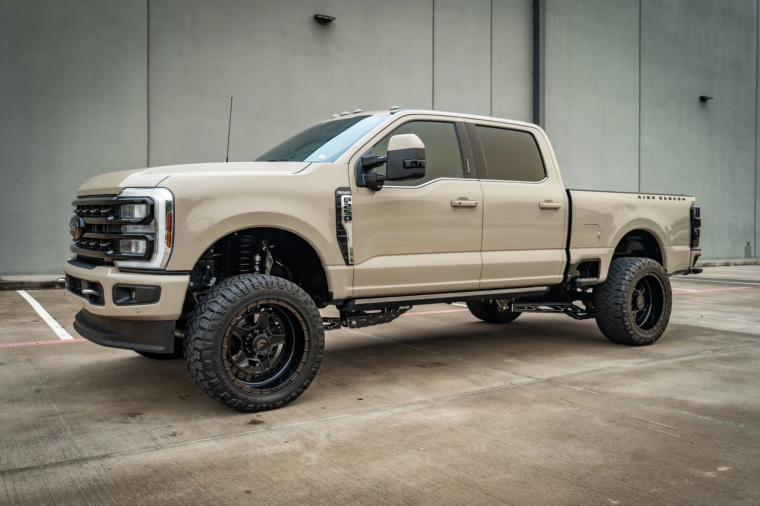 Tan Ford Super Duty with a leveling kit and offroad tires