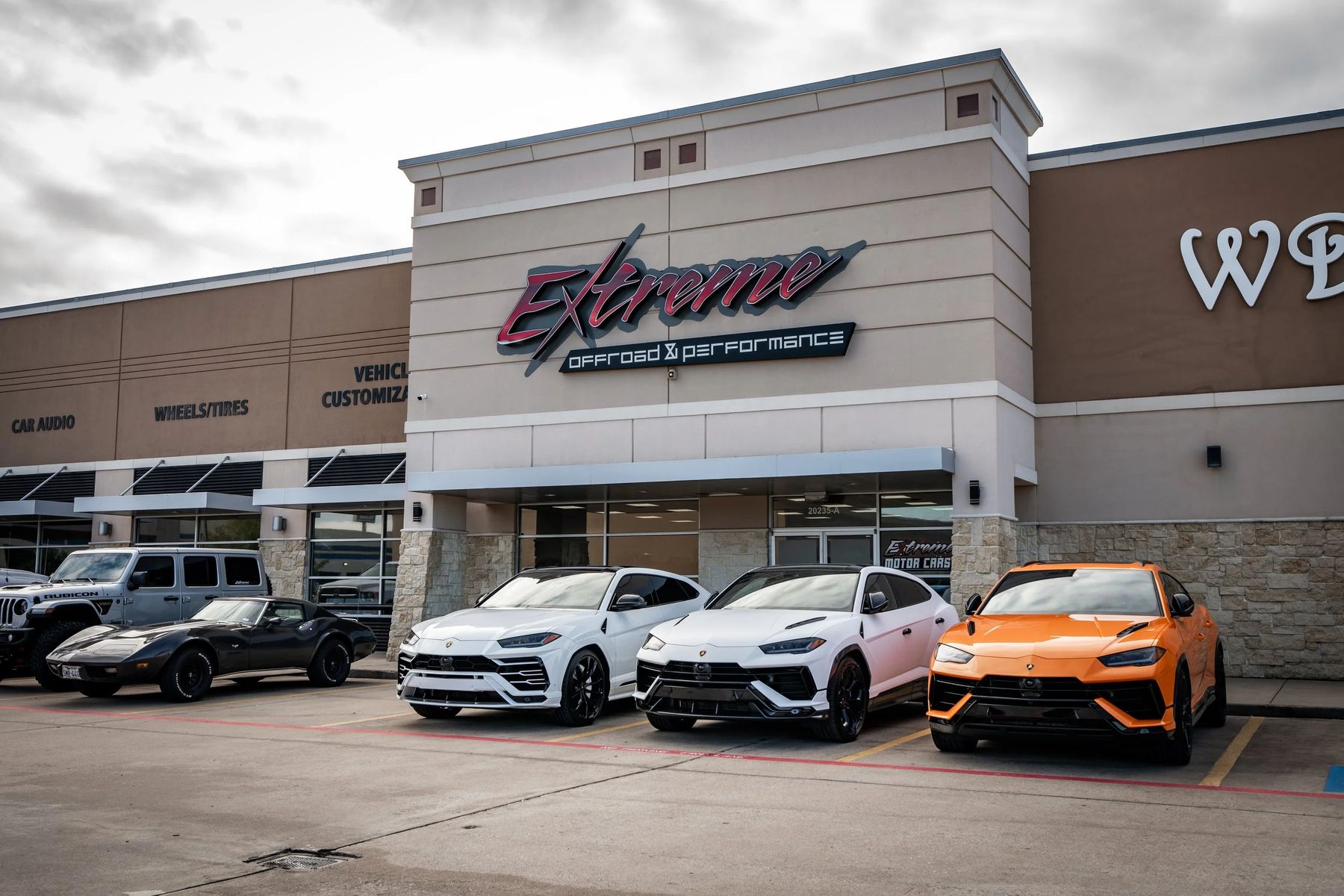 The Extreme Offroad and Performance storefront in Katy with customized Lamborghini Urus SUVs parked out front